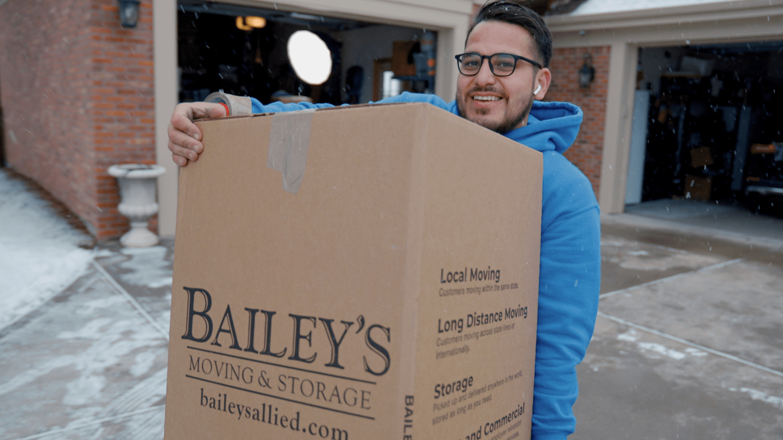 Man moving boxes from his home to a storage unit 